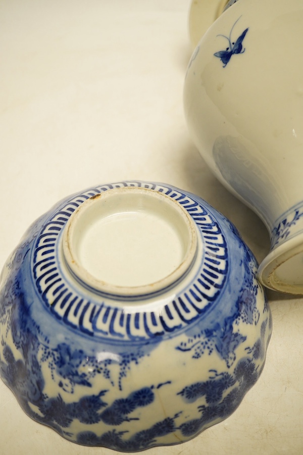 An early 20th century Chinese blue and white porcelain vase and cover decorated with figures in a landscape and a Japanese circular bowl, tallest 23cm. Condition - good